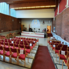 salvation army photo of a hall with a lot of chairs facing the scene